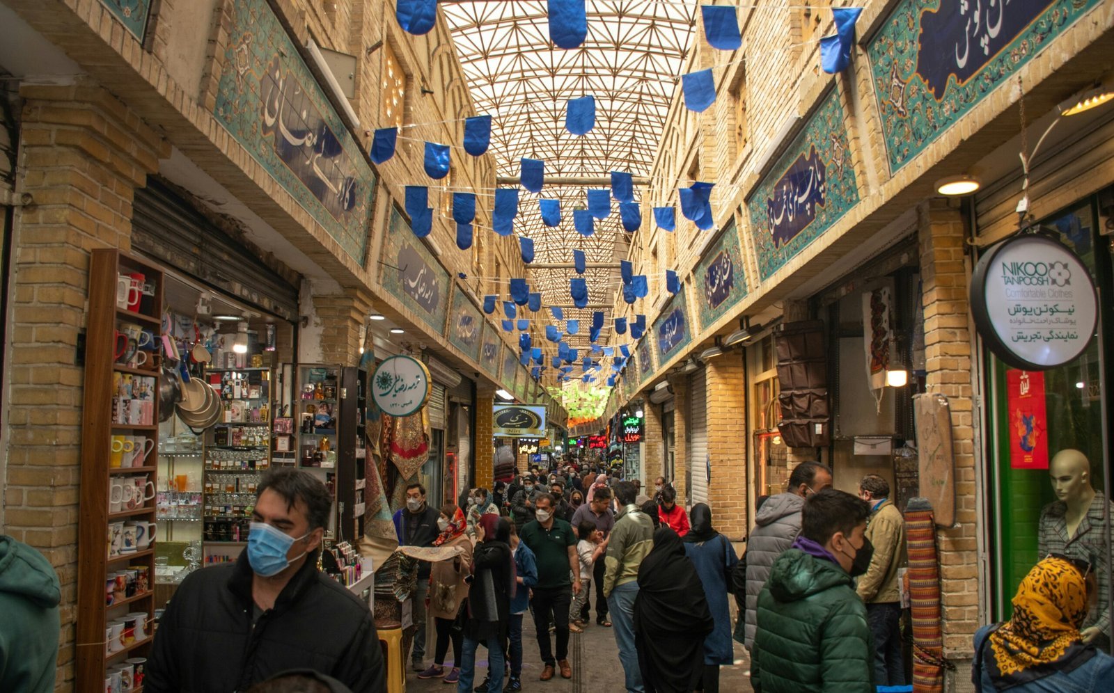 a group of people walking through a shopping mall